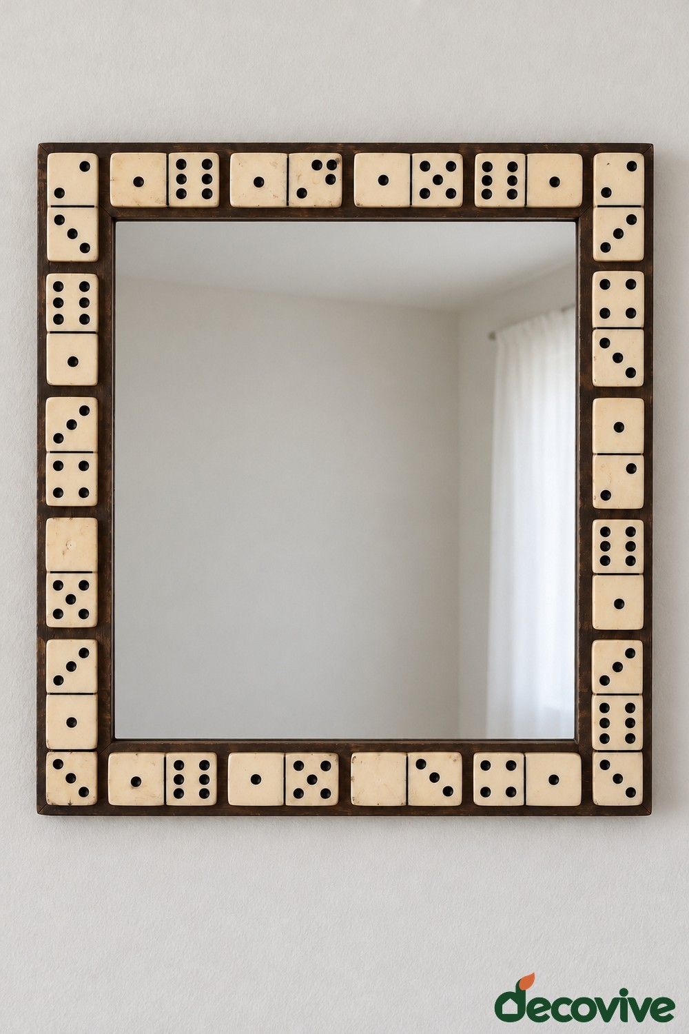 Rectangular mirror with cream and black dominoes arranged around a dark wooden frame