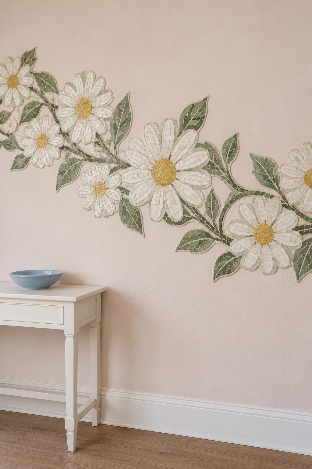 Large white and yellow mosaic daisies with green leaves sweeping diagonally across a blush wall