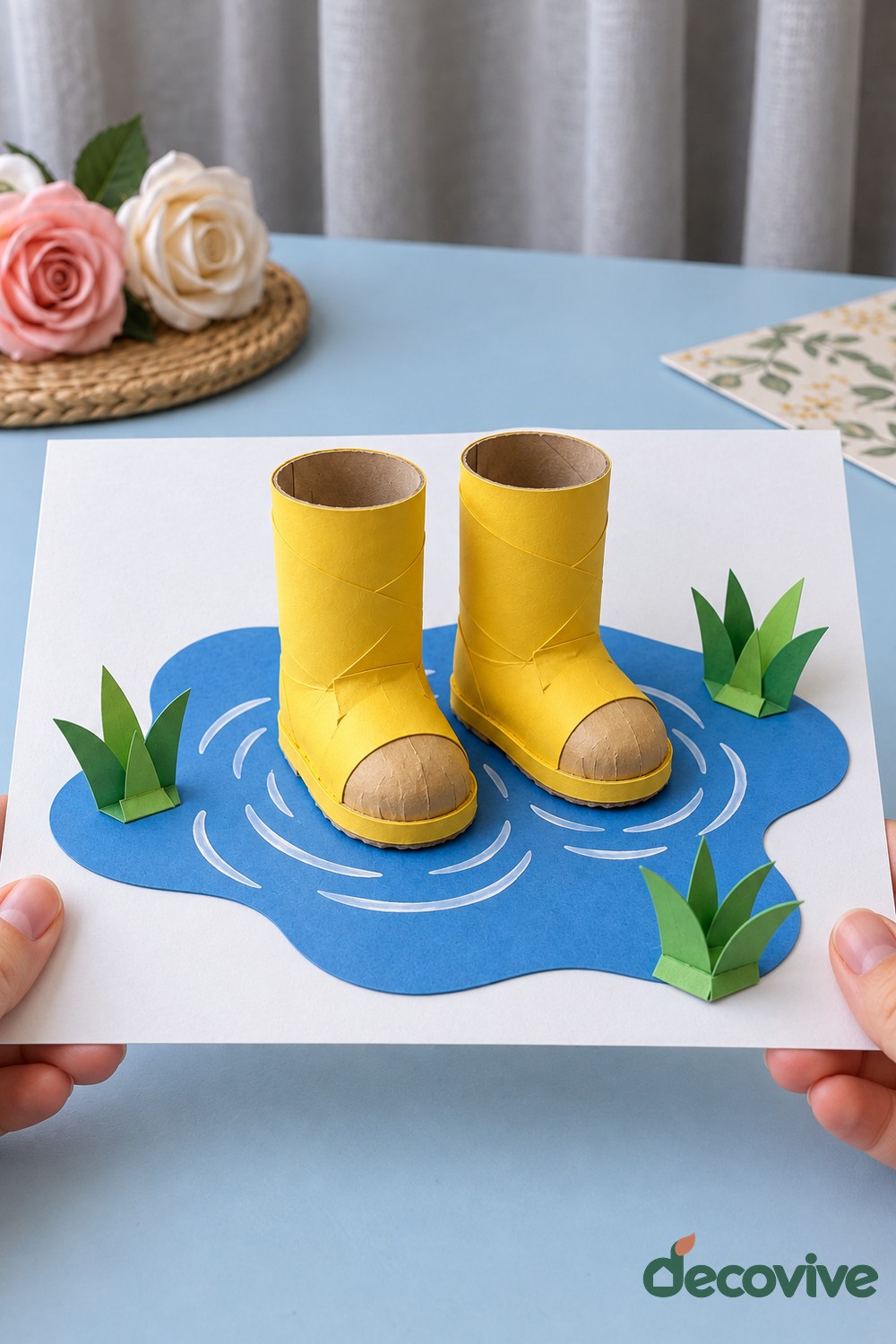 Finished cardboard rain boots in a paper puddle