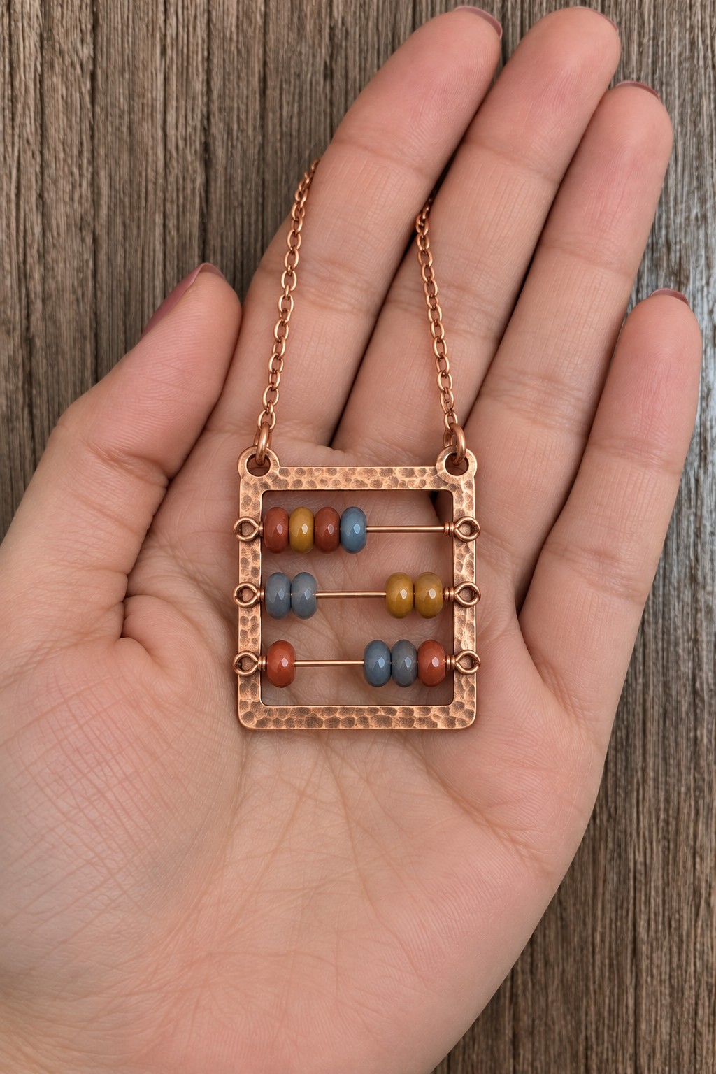 Rectangular copper abacus pendant with three horizontal rods and colorful small beads