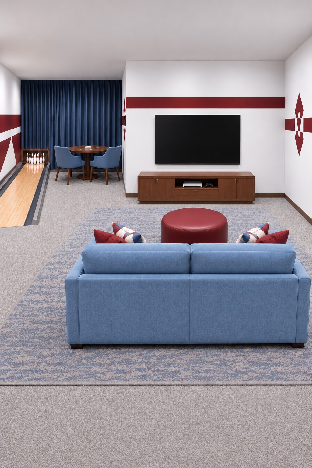 Blue sofa and red ottoman facing a television beside a compact bowling lane and rear game table