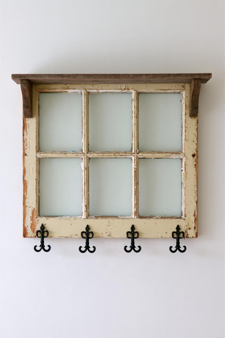 Rustic old window frame adapted into an entryway shelf with hooks