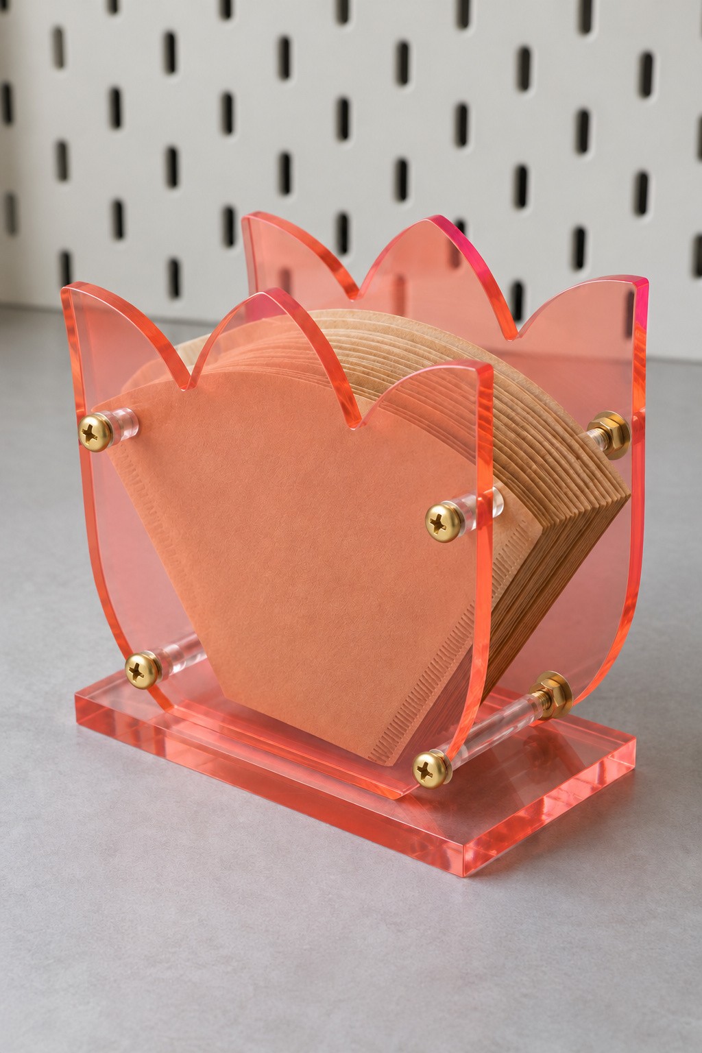 Coral acrylic tulip coffee filter holder with brass spacers and a matching base