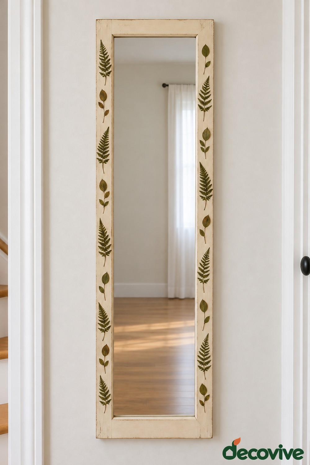 Tall cream rectangular mirror with green fern and leaf motifs on the side borders