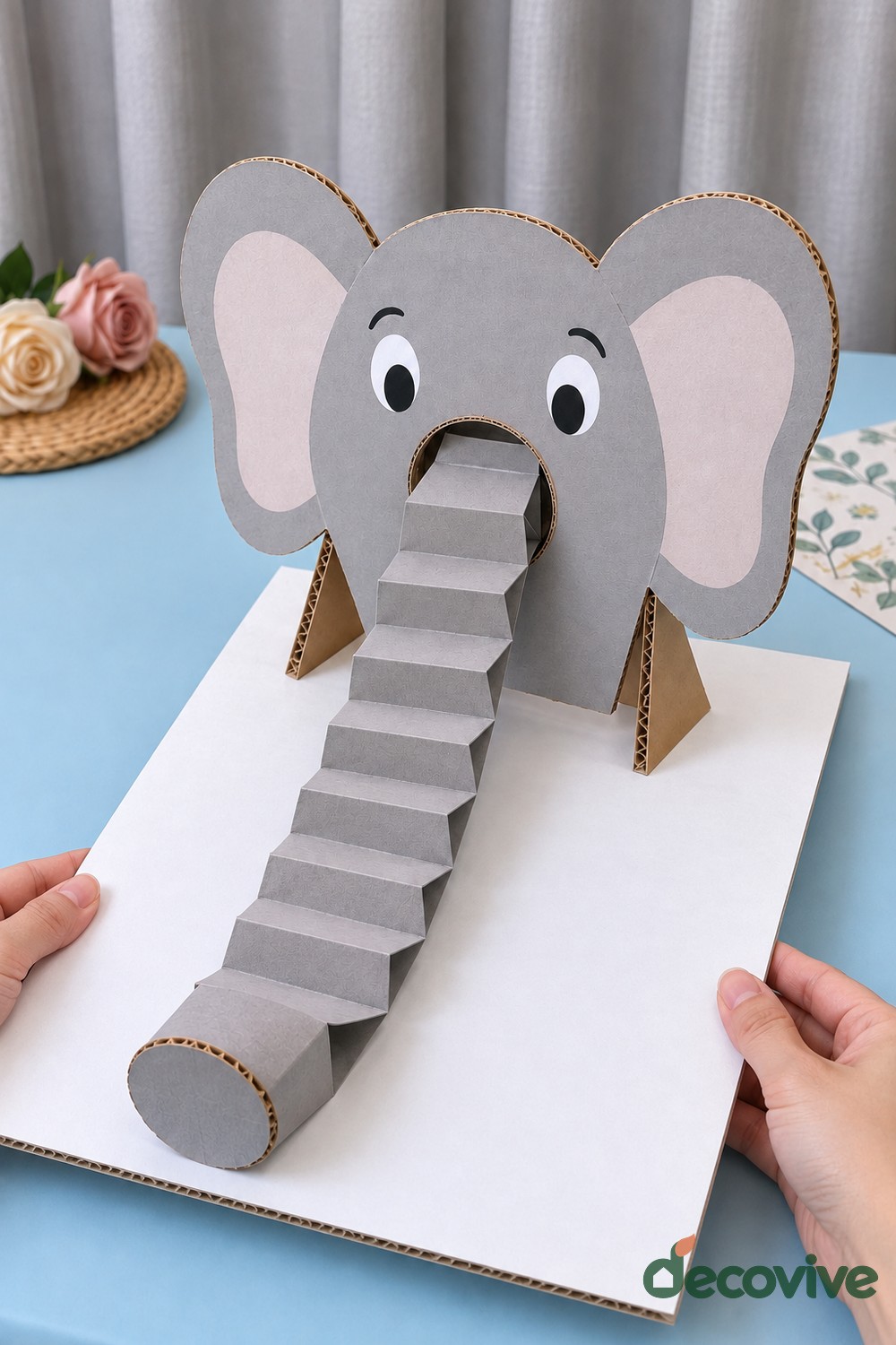 Finished standing cardboard elephant with an accordion trunk